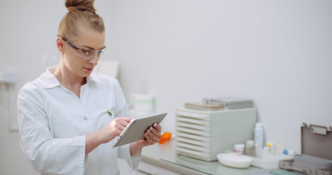 Female-Doctor-Using-Digital-Tablet-At-Dental-Clinic