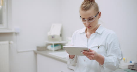 Female-Doctor-Using-Digital-Tablet-At-Dental-Clinic-1