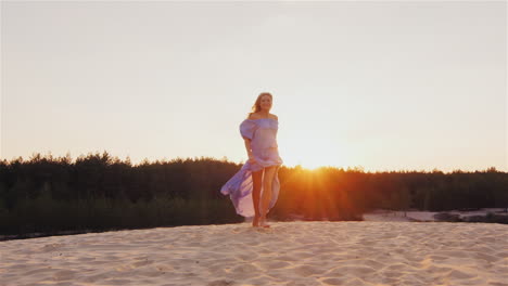 A-Young-Woman-In-A-Light-Dress-Air-Runs-At-Sunset-On-The-Beach