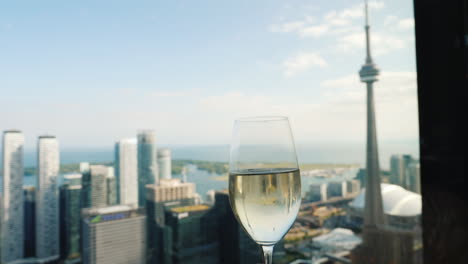 Raise-A-Glass-Of-Champagne-By-The-Window-Where-You-Can-See-The-Famous-Cn-Tower---A-Symbol-Of-Toronto