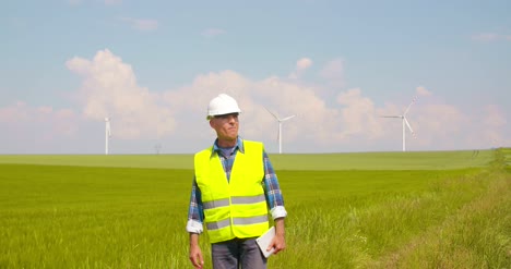 Engineer-Using-Digital-Tablet-On-Wind-Turbine-Farm