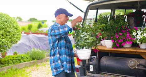 Gardener-Loading-Flower-Pots-In-Van-Trunk