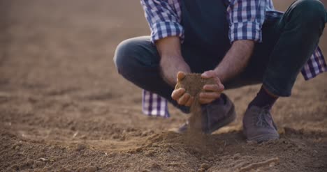 Hands-Examining-Soil-In-Agricultural-Field-8