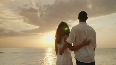 A-Couple-In-Love-Admires-The-Sunset-Over-The-Sea-Back-View