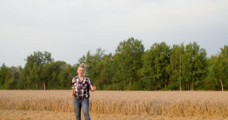 Young-Positive-Female-Farmer-Dancing-At-Farm