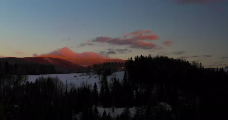 Luftaufnahme-Von-Schneebedeckten-Bergen-Und-Wäldern-Bei-Sonnenuntergang-Im-Winter-1