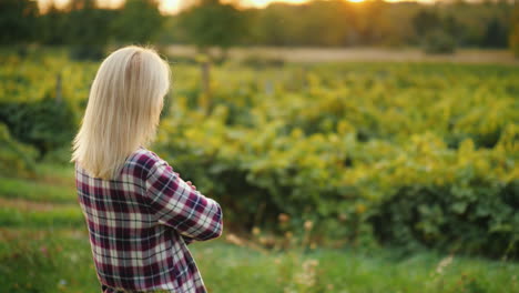 A-Woman-Farmer-Is-Looking-Forward-To-His-Vineyard-The-Owner-Of-The-Farm-Business-Back-View