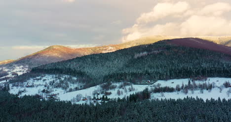 Aerial-View-Of-Forest-Covered-With-Snow-In-Mountains-7