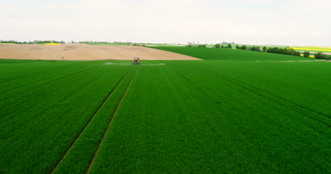 Agriculture-Aerial-Of-Tractor-Spraying-Farm-Land-With-Pesticide-7