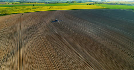 Agriculture-Aerial-Shoot-Of-Tractor-Working-On-Field-