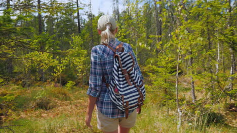 A-Woman-Walks-Through-The-Marshland-In-The-Forest-Back-View-Dangerous-Trek-And-Get-Lost-Concept