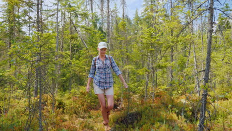 A-Woman-Walks-Through-The-Marshland-In-The-Forest-Back-View-Dangerous-Trek-And-Get-Lost-Concept