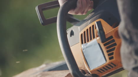 Close-Up-Of-Man-Using-Chainsaw-