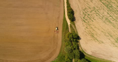 Aerial-View-Of-Tractor-Plowing-Field