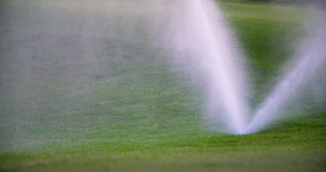 Medium-Shot-Of-Grass-Sprinkler-Splashes-Water-Over-The-Lawn-2