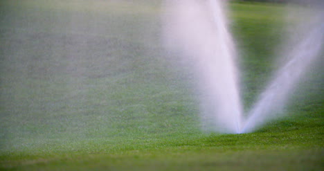 Medium-Shot-Of-Grass-Sprinkler-Splashes-Water-Over-The-Lawn-3