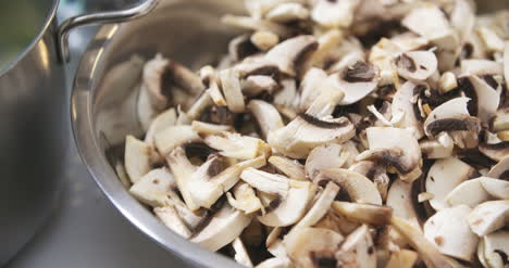 Chef-Slicing-Mushrooms-In-Kitchen