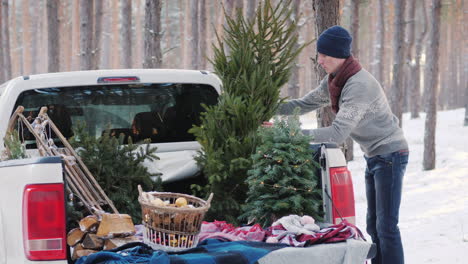 A-Young-Man-Is-Shipping-A-New-Year-Tree-In-The-Back-Of-A-Pickup-Truck-Preparing-For-Christmas