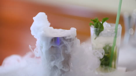 Dry-Ice-In-Glass-While-Bartender-Preparing-Drink-2