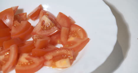 Cooking-Chopped-Tomatos-On-Plate-In-Kitchen-1