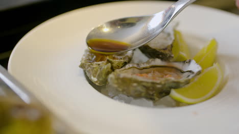 Chef-Preparing-Oysters-Dish-In-Elegant-Restaurant-4