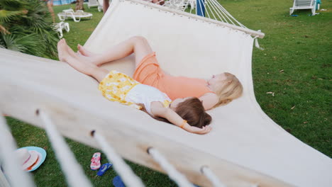 Two-Girls-In-Bright-Summer-Clothes-Are-Lying-On-The-Deckchair-Having-Fun-Enjoying-The-Rest-View-From