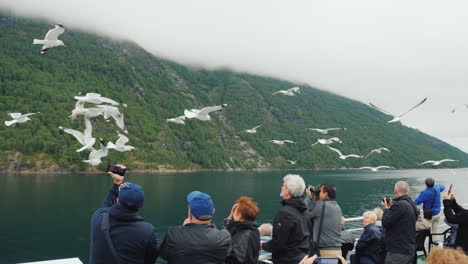 A-Group-Of-Tourists-On-A-Cruise-Ship-Feeding-Gulls
