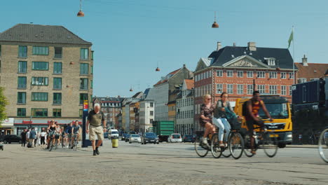 A-Lively-Street-In-The-Central-Part-Of-Copenhagen-Along-A-Bicycle-Path-A-Group-Of-Cyclists-Rides-Wal