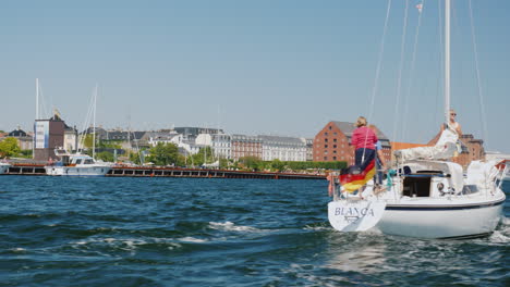 The-Yacht-With-The-Flag-Of-Germany-Sails-Against-The-Background-Of-Copenhagen\'s-City-Line-Euro-Trip