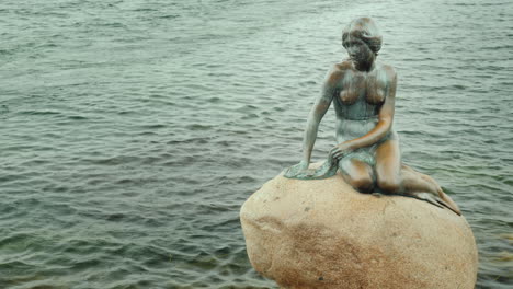 Copenhagen\'s-Famous-Landmark---The-Little-Mermaid-Statue-On-A-Rainy-Cloudy-Day