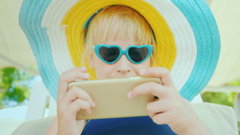 The-Child-Relaxes-After-Swimming-In-The-Pool---Plays-On-The-Smartphone