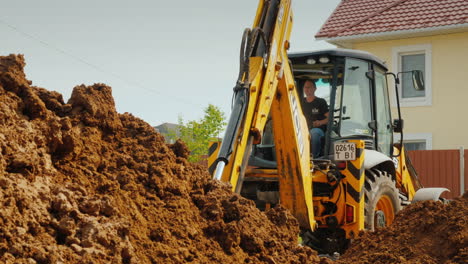 Excavator-Digs-A-Trench-Near-Private-Cottages