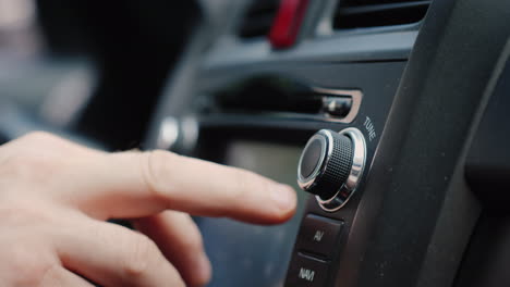 Male-Hand-Adjusts-The-Tuning-Of-The-Car-Radio-Close-Up-Shot