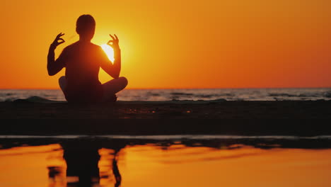 Young-Woman-Meditates-In-A-Picturesque-Place-At-Sunset