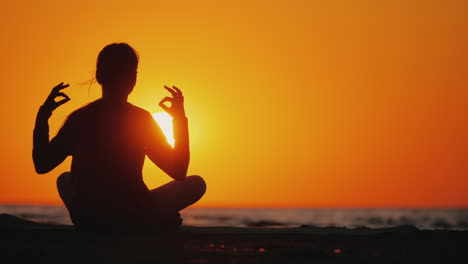 Young-Woman-Meditates-In-A-Picturesque-Place-At-Sunset