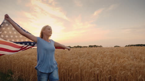 Woman-With-Usa-Flag-Runs-In-The-Sun-On-A-Wheat-Field