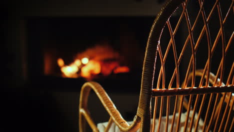 An-Empty-Rocking-Chair-Sways-By-The-Fireplace-Next-To-A-Set-For-Needlework