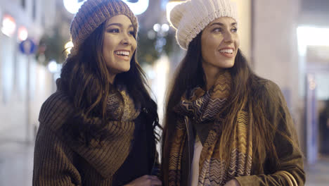 Two-smiling-happy-women-in-winter-outfits