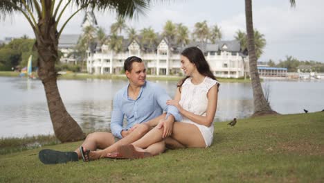Joyful-couple-tourists-spending-time-on-lawn