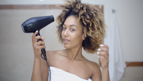Woman-Drying-Her-Hair-With-Hairdryer