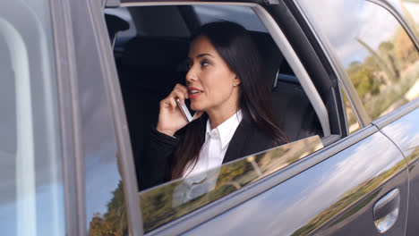 Beautiful-business-woman-on-phone-in-automobile