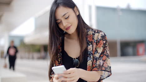 Young-woman-sitting-reading-a-text-message