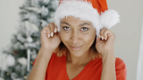 Attractive-young-woman-donning-a-Santa-hat