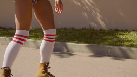 Female-Legs-On-Vintage-Roller-Skater-On-The-Road-