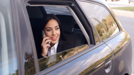Curious-business-woman-on-phone-looking-from-car
