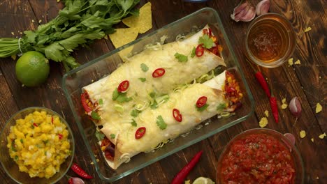 Homemade-Vegetable-Burritos-served-in-heatproof-dish--With-salsa--guacamole--nachos-and-ingredients