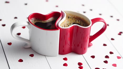 Two-heart-shaped-coffee-cups-conected-with-each-other-