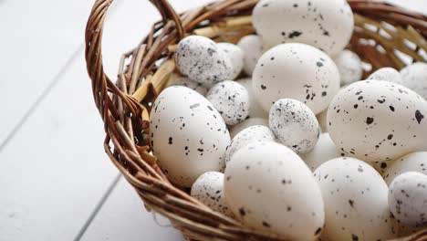 Basket-of-white-dotted-Pascua-eggs-in-brown-wicker-basket