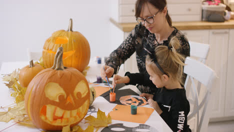 Mother-and-daughter-painting-jack-o-lantern