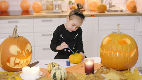 Girl-painting-pumpkin
